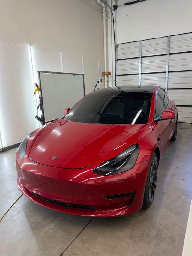 Red Tesla Model 3 with Phantom Tint